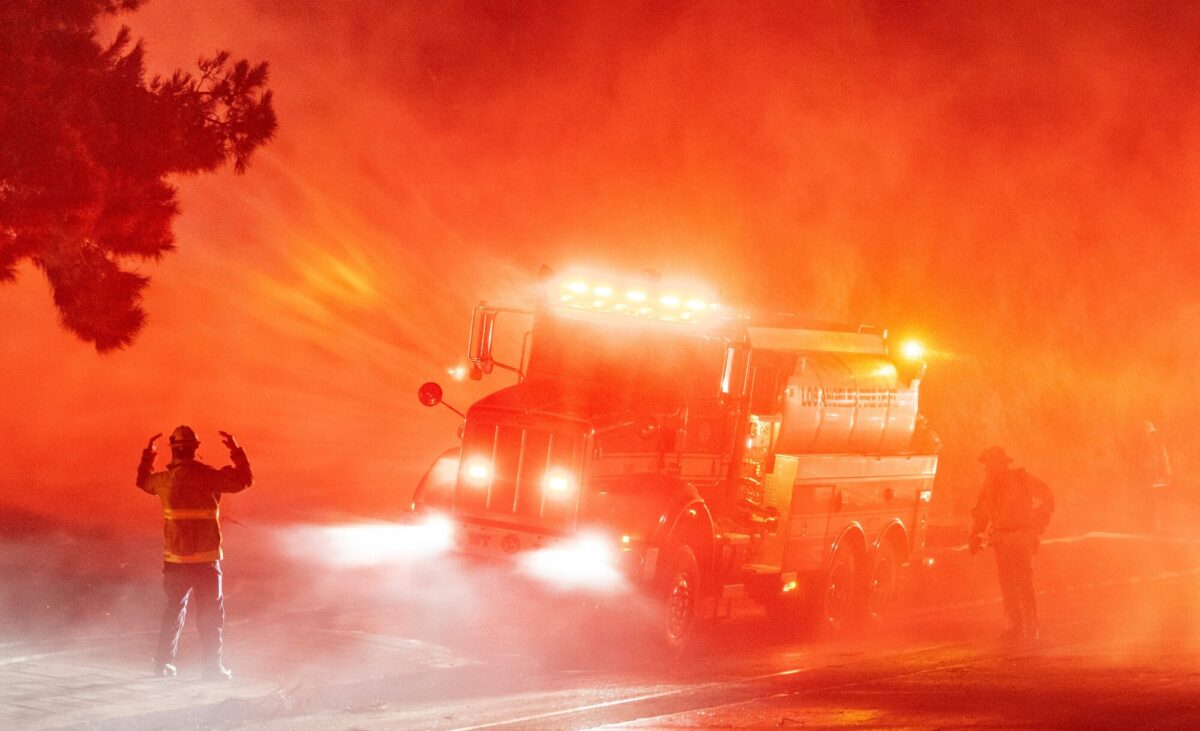 Firefighters spray down flames