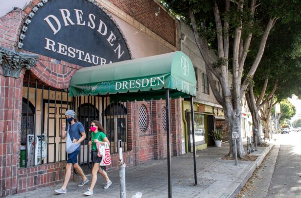 People walk past a closed restaurant in Los Angeles, Calif., on Dec. 8, 2020. (Valerie Macon/AFP via Getty Images)