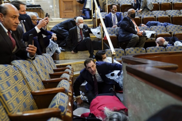 People shelter in the House gallery as protesters try to break into the House Chamber at the U.S. Capitol in Washington on Jan. 6, 2021. (Andrew Harnik/AP Photo)