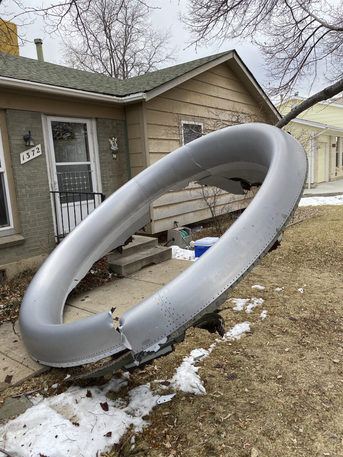 Debris is scattered in the front yard of a house at near 13th and Elmwood, in Broomfield, Colo., on Feb. 20, 2021. (Broomfield Police Department via AP)