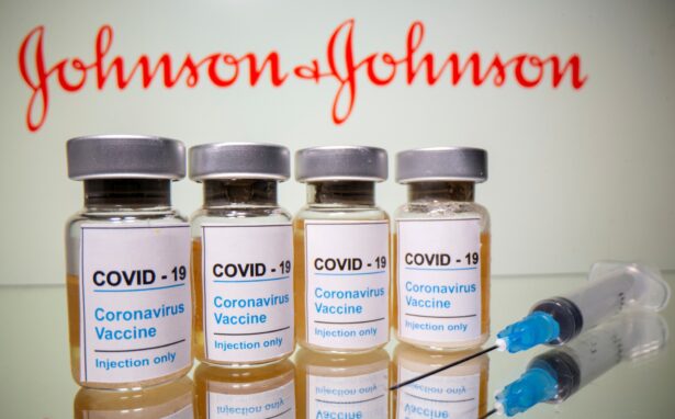 Vials with a sticker reading, "COVID-19 / Coronavirus vaccine / Injection only" and a medical syringe are seen in front of a displayed Johnson & Johnson logo in this illustration taken Oct. 31, 2020. (REUTERS/Dado Ruvic/Illustration)