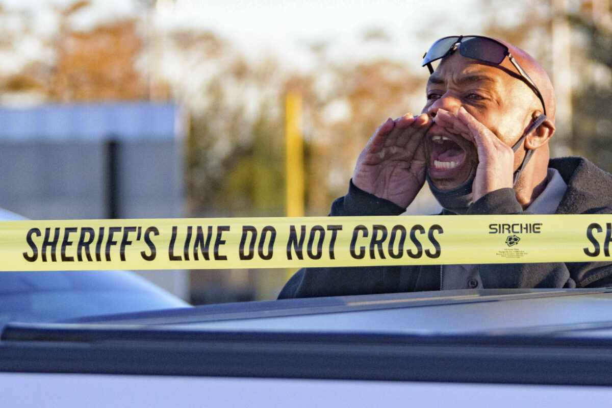 A man cries out "Where is my son?" at the scene of a multiple fatality shooting at the Jefferson Gun Outlet in Metairie, La., on Feb. 20, 2021. (AP Photo/Matthew Hinton)