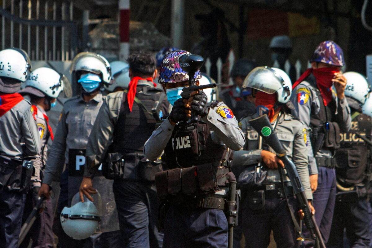 A riot police officer fires a rubber bullet toward protesters during a protest against the military coup in Yangon, Myanmar, on Feb. 28, 2021. (Stringer via Reuters)