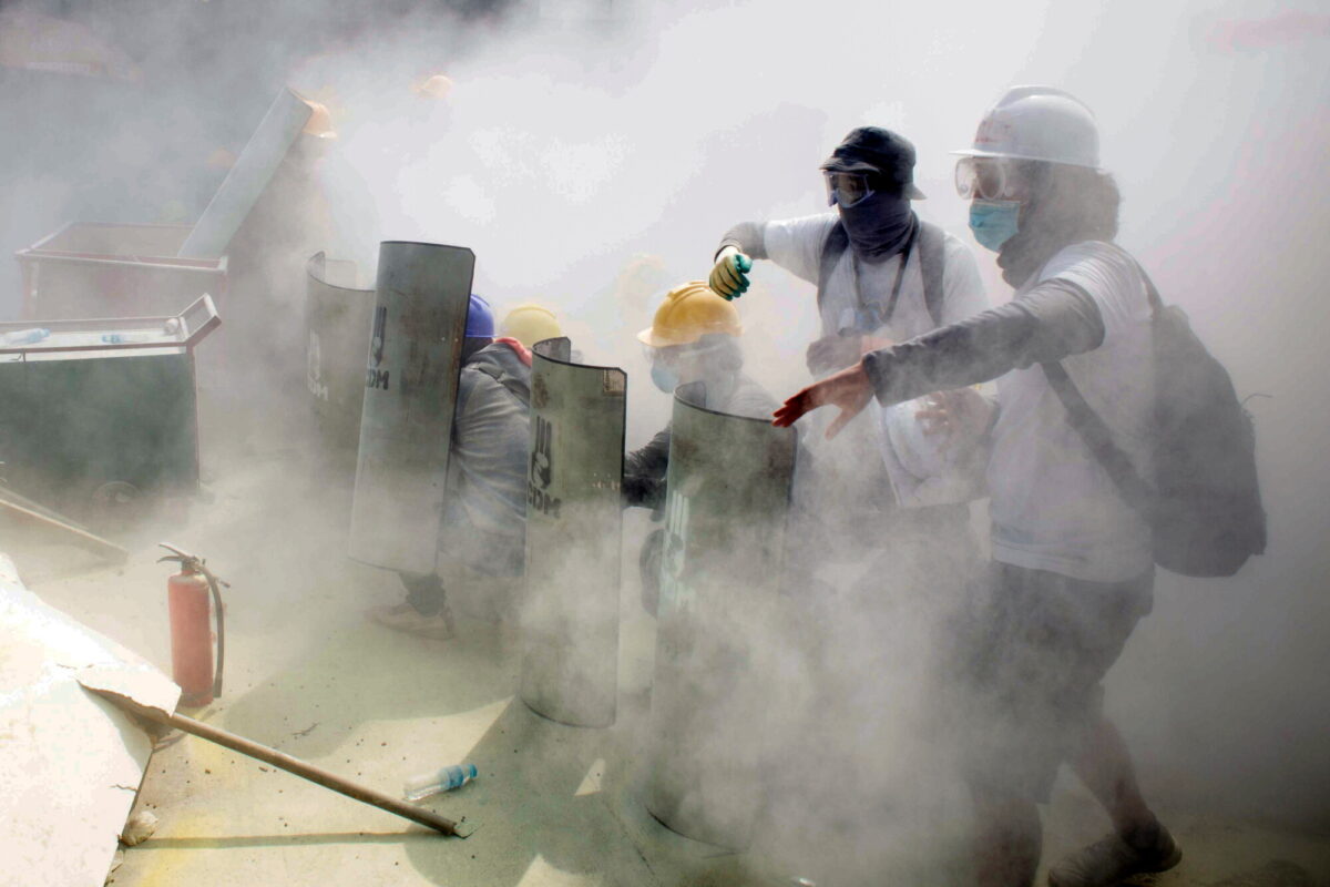 Demonstrators clash with riot police officers during a protest against the military coup in Yangon, Burma, on Feb. 28, 2021. (Stringer/Reuters)