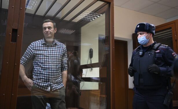 Russian opposition leader Alexei Navalny stands inside a glass cell during a court hearing at the Babushkinsky district court in Moscow on Feb. 20, 2021. (Kirill Kudryavtsev/AFP via Getty Images)