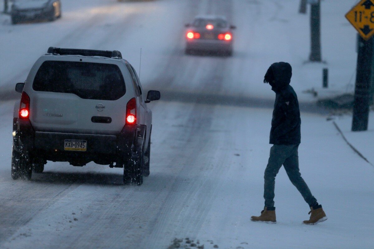 man-walks-in-icy-road