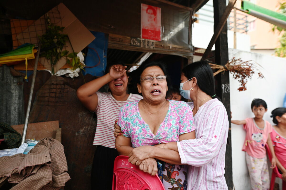 Family members of Aung Than, 41, who was killed during a raid by security forces cry at their home in Thaketa, Yangon