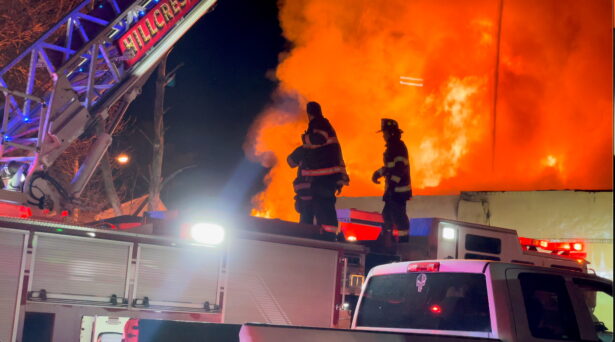 Firefighters work at a site of a fire