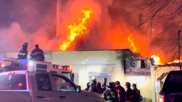 Firefighters work at a site of a fire