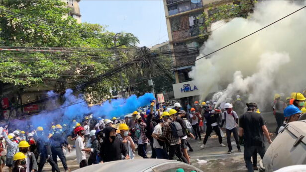 Protesters set off smoke grenades to block the view from snipers in Sanchaung, Yangon, Burma, on March 3, 2021. (Reuters)