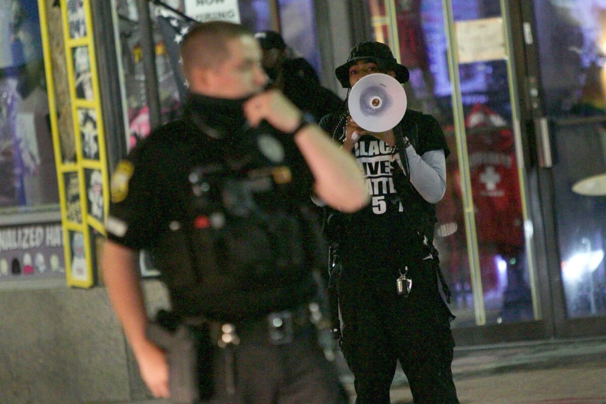 A Virginia Beach police officer redirects traffic along Atlantic Avenue following a fatal shooting on March 27, 2021. (Karen Zeis/The Virginian-Pilot via AP)