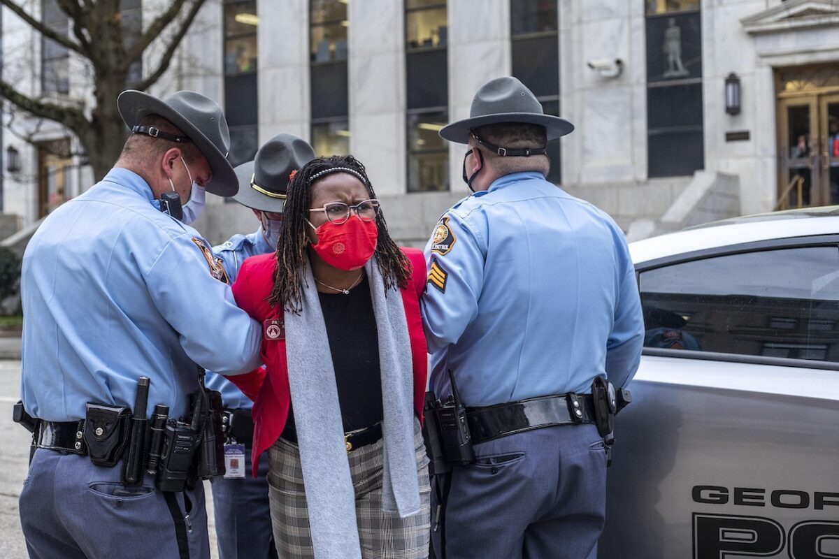 Georgia State Rep. Park Cannon (D-Atlanta) is placed into the back of a Georgia State Capitol patrol car after being arrested by Georgia State Troopers at the Georgia State Capitol Building in Atlanta, Georgia, on March 25, 2021. (Alyssa Pointer/Atlanta Journal-Constitution via AP)