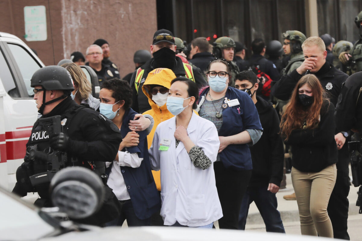 People are led out of a King Soopers grocery store after a shooting in the store, in Boulder, Colo., on March 22, 2021. (Hart Van Denburg/Colorado Public Radio via AP)