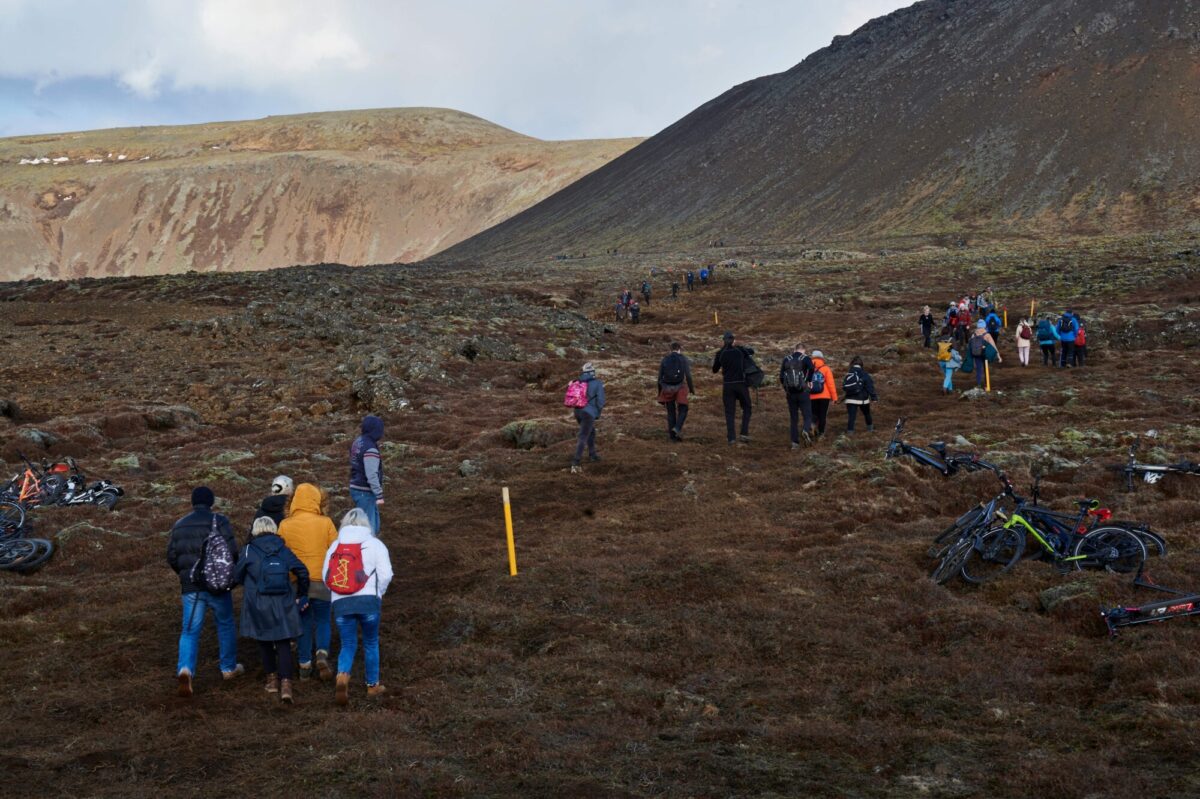 Hikers walk towards Fagradalsfjall area