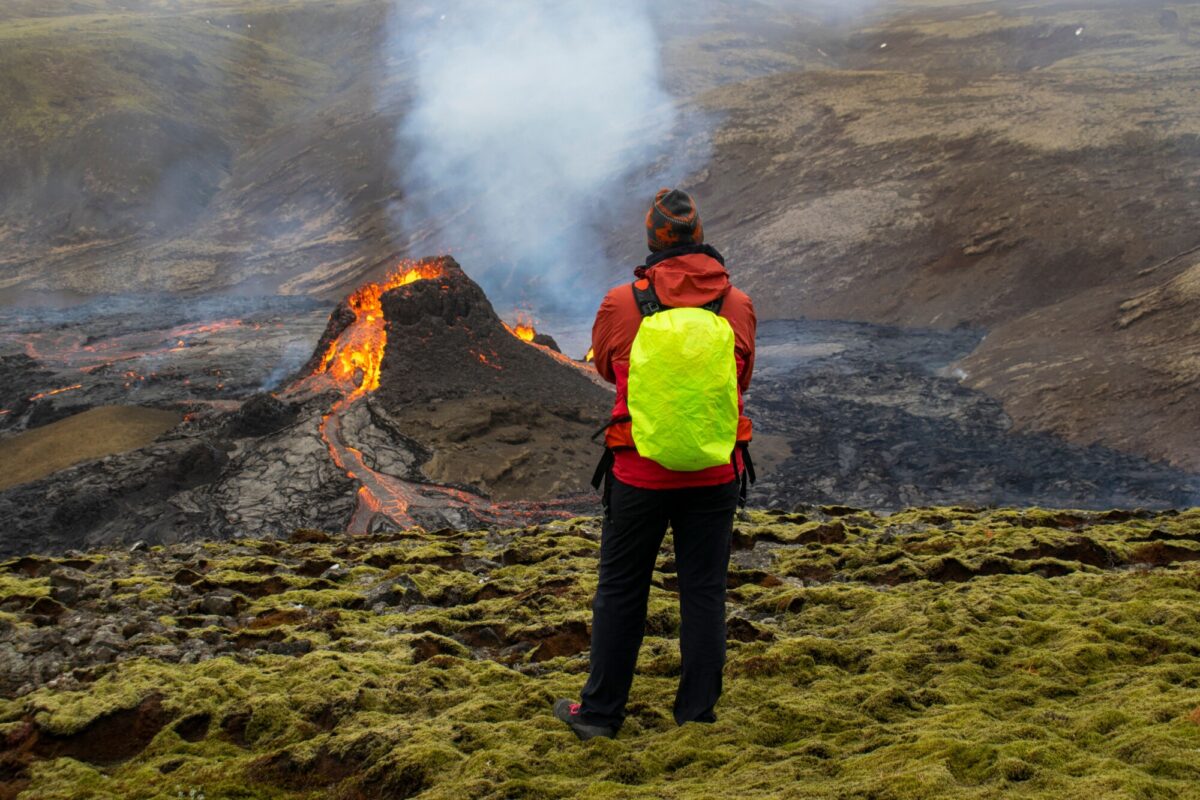 Hikers look at the lava flowing