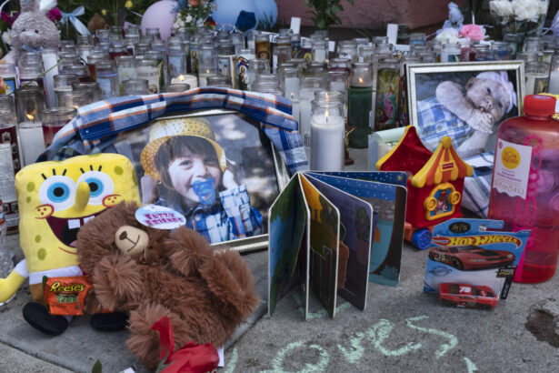 Photos, candles, flowers and balloons are placed as a memorial for three children who were killed at the Royal Villa apartments complex in the Reseda section of Los Angeles, on April 12, 2021. (Richard Vogel/AP Photo)