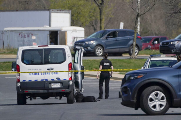 A crime scene technician stands near the scene of a shooting at a business park in Frederick, Md., on April 6, 2021. (Julio Cortez/AP Photo)