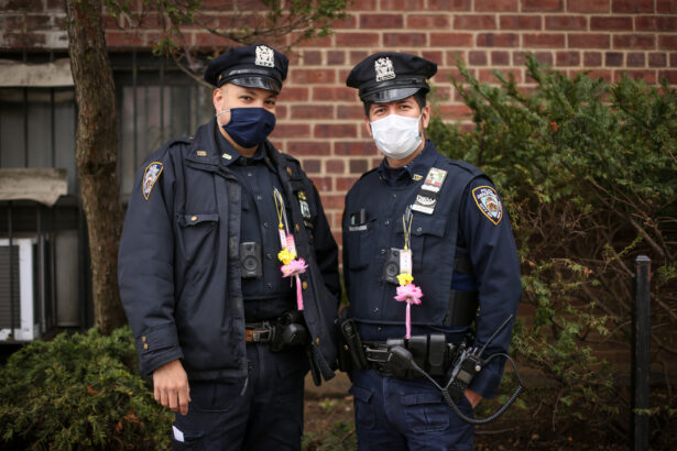 Police officers stand by as Falun Gong practitioners take part in a parade in Flushing, New York, on April 18, 2021, to commemorate the 22nd anniversary of the April 25th peaceful appeal of 10,000 Falun Gong practitioners in Beijing. (Samira Bouaou/The Epoch Times)