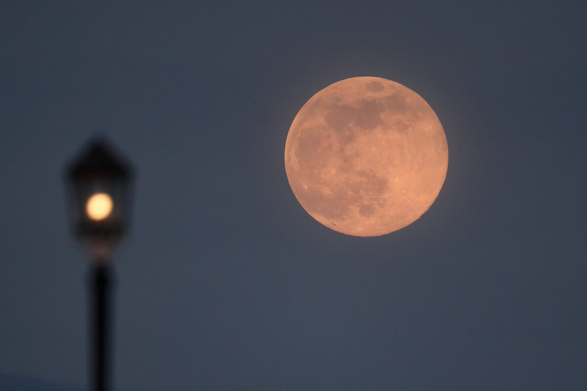 A supermoon rises over Worthing pier in Worthing, United Kingdom, on April 7, 2020. (Mike Hewitt/Getty Images)