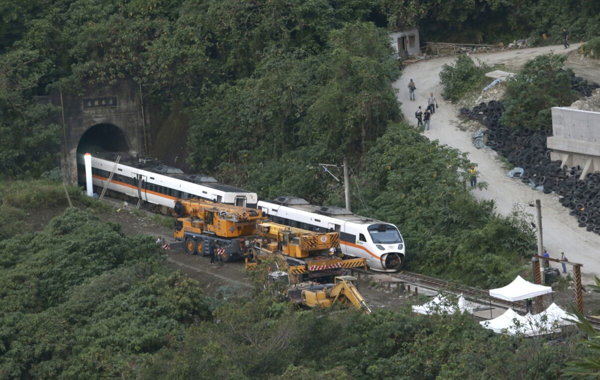 Rescue workers remove a part of the derailed train near Taroko Gorge in Hualien, Taiwan, on April 3, 2021. (Chiang Ying-ying/AP Photo)