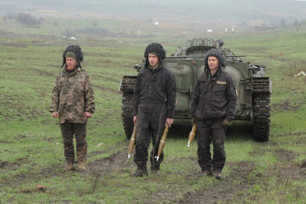 Service members of the Ukrainian armed forces stand next to an armored vehicle during a training at a firing range in Donetsk region, Ukraine, on April 20, 2021. (Serhiy Takhmazov/Reuters