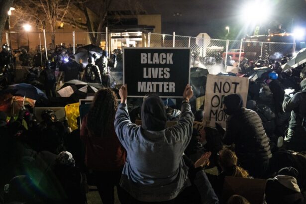 People take part in a demonstration outside the Brooklyn Center Police Department in Brooklyn Center, Minn., on April 14, 2021. (John Minchillo/AP Photo)