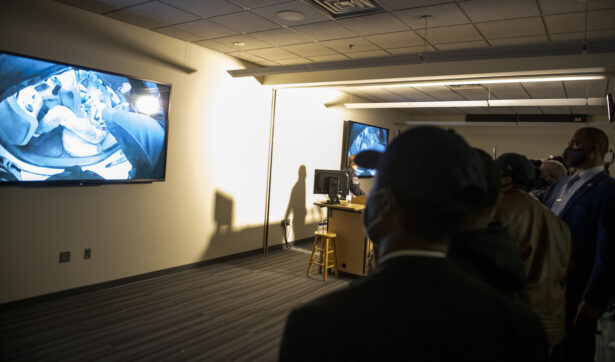 People watch as the body camera footage of the killing of 20-year-old Daunte Wright is played during a press conference at the Brooklyn Center police headquarters in Brooklyn Center, Minnesota, on April 12, 2021. (Stephen Maturen/Getty Images)