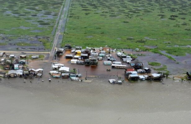 Housing surrounded by flood waters caused by Hurricane Harvey is seen from a U.S. Coast Guard helicopter during an overflight from Port Aransas to Port O'Connor, Texas, on Aug. 26, 2017. (U.S. Coast Guard/Petty Officer 3rd Class Johanna Strickland/Handout via Reuters)