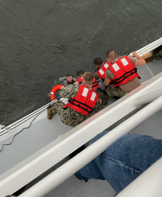 The crew of the Coast Guard Cutter Glenn Harris pulls a person from the water after a 175-foot commercial lift boat capsized eight miles south of Grand Isle, Louisiana, on April 13, 2021. (USCG/Coast Guard Cutter Glenn Harris)