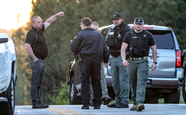 Law enforcement work the scene scene following a police chase in Carroll County, Ga., on April 12, 2021. (John Spink/Atlanta Journal-Constitution via AP)