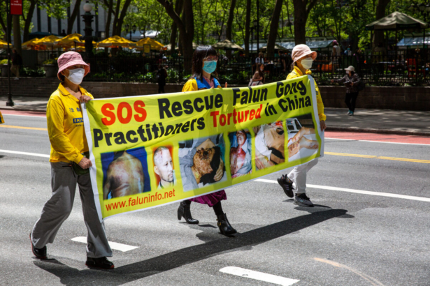 Practitioners of the spiritual discipline Falun Gong hold a parade in New York City on May 13, 2021. (Chung I Ho/The Epoch Times)