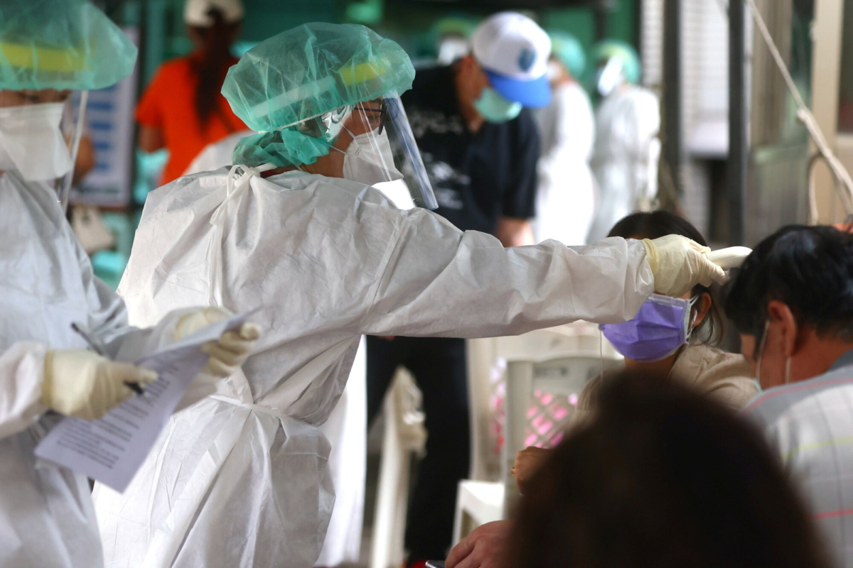 A healthcare frontline worker prepares people to get their rapid test following a surge of coronavirus infections in Taipei, Taiwan, on May 17, 2021. (Ann Wang/Reuters)