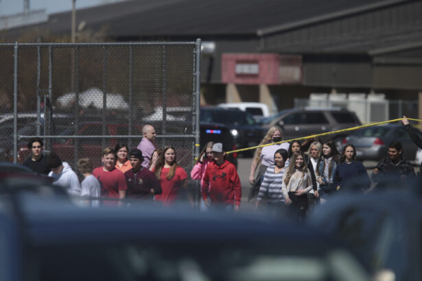Students walk past police tape after a school shooting at Rigby Middle School in Rigby, Idaho, on May 6, 2021. (John Roark/The Idaho Post-Register via AP)
