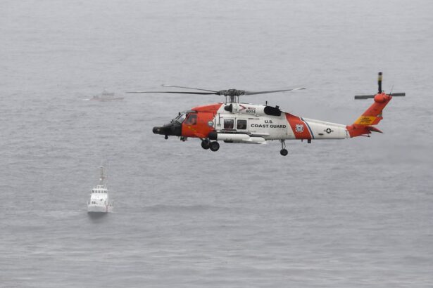 A U.S. Coast Guard helicopter flies over boats searching the area where a boat capsized just off the San Diego coast, Calif., on May 2, 2021. (Denis Poroy/AP Photo)