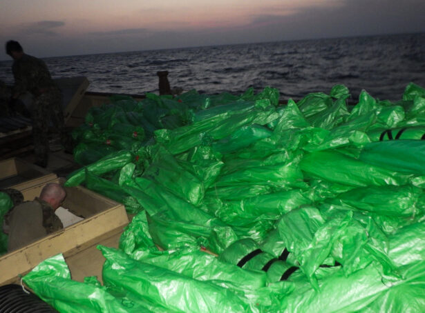 Plastic-wrapped weapons are seen on the deck of a stateless dhow that the U.S. Navy said carried a hidden arms shipment in the Arabian Sea, on May 7, 2021. (U.S. Navy via AP)