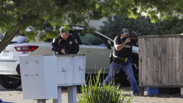 Officers take aim at an apartment across Camilla Court in San Luis Obispo, Calif., on May 10, 2021. (David Middlecamp/The Tribune (of San Luis Obispo) via AP)