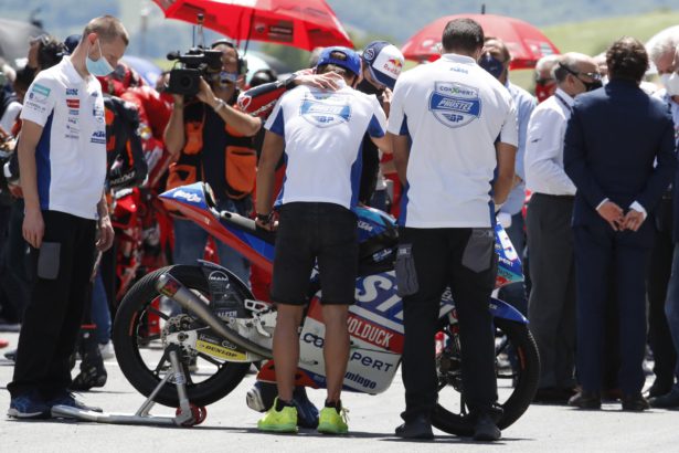 Teammates of 19-year-old Swiss rider Jason Dupasquier stand near his motorbike as they pay a minute of silence in his memory prior to the start of the MotoGP Grand Prix of Italy at the Mugello circuit, in Scarperia, Italy, on May 30, 2021. (Antonio Calanni/AP Photo)