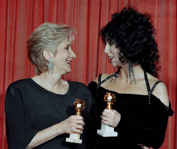 Actress Olympia Dukakis, winner of a Golden Globe for "Best Performance in a Supporting Role" and Cher, winner of the "Best Performance by an Actress in a musical or comedy", hold the awards they received for performances in the hit movie "Moonstruck" during the Foreign Press Awards at the Beverly Hilton Hotel, on Jan. 24, 1988. (Reed Saxon/AP)