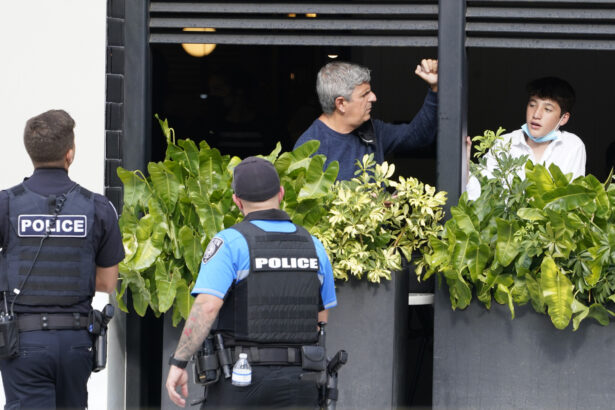 Shoppers look from a restaurant as police officers enter the Aventura Mall after a shooting left three people injured and several suspects in custody, in Aventura, Fla., on May 8, 2021. (Marta Lavandier/AP Photo)