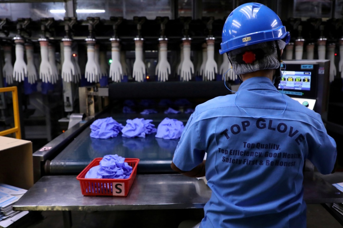 A worker works at a production line in Top Glove factory in Shah Alam, Malaysia, on Aug. 26, 2020. (Lim Huey Teng/File Photo/Reuters)
