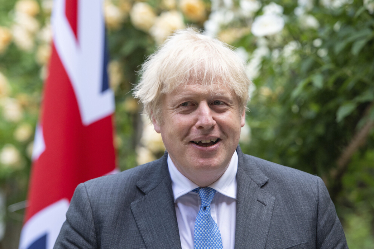 Britain's Prime Minister Boris Johnson reacts as he walks with Australian Prime Minister Scott Morrison after their meeting, in the garden of 10 Downing Street, in London, on June 15, 2021. (Dominic Lipinski/Pool via AP)