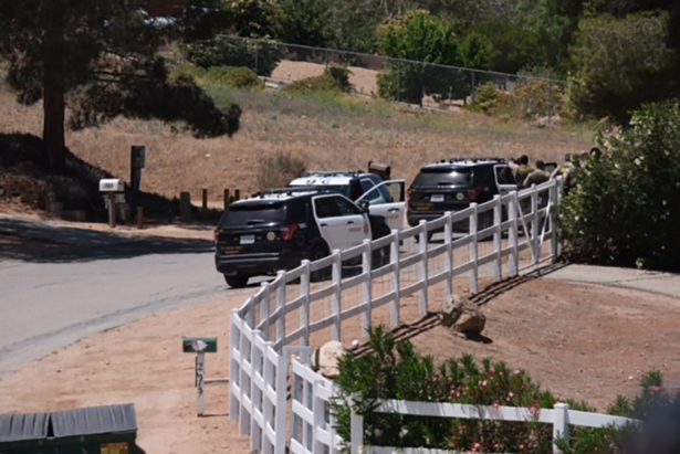 Police vehicles appear on the scene of a fire near a home in Acton, Calif., on June 1, 2021. (David Crane/The Orange County Register via AP)
