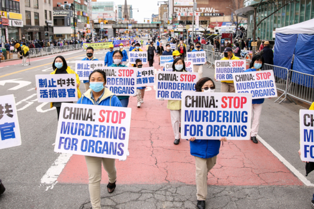 Falun Gong practitioners take part in a parade in Flushing, New York, on April 18, 2021, to commemorate the 22nd anniversary of the April 25th peaceful appeal of 10,000 Falun Gong practitioners in Beijing. (Samira Bouaou/The Epoch Times)