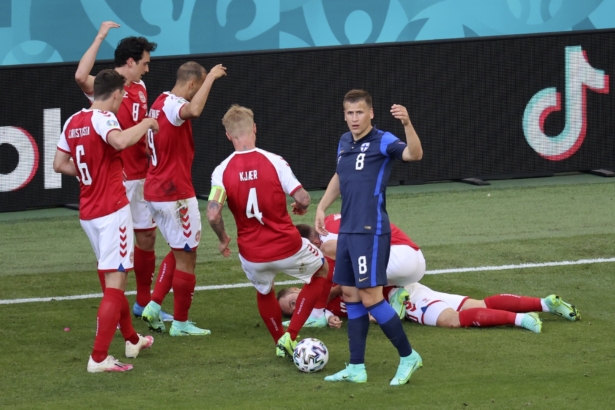 Denmark's players go to his teammate Christian Eriksen after he collapsed during the Euro 2020 soccer championship group B match between Denmark and Finland at Parken stadium in Copenhagen, Denmark, on June 12, 2021. (Wolfgang Rattay/Pool via AP)