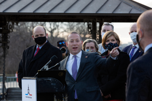 Rep. Josh Gottheimer (D-N.J.) speaks at the podium standing with members of the Problem Solvers Caucus to praise the forthcoming passage of the bipartisan emergency COVID-19 relief bill in a press conference outside the U.S. Capitol in Washington, on Dec. 21, 2020. (Cheriss May/Getty Images)