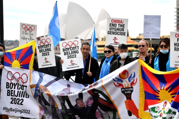 Protesters hold up placards and banners as they attend a demonstration to call on the Australian government to boycott the 2022 Beijing Winter Olympics over China's human rights record in Sydney, Australia, on June 23, 2021. (Saeed Khaan/AFP via Getty Images)