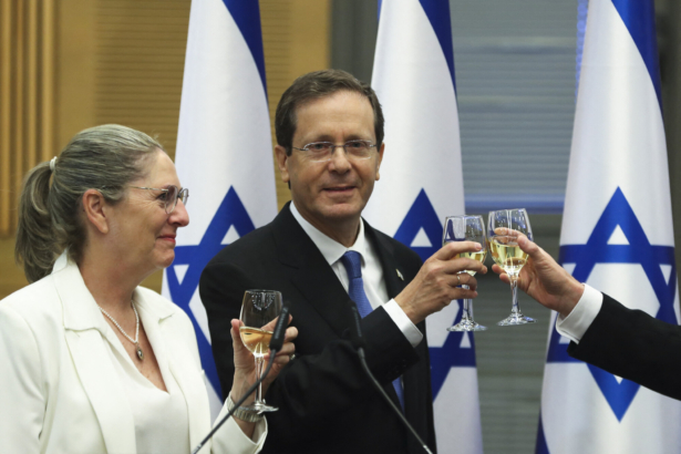 President-elect Isaac Herzog and his wife Michal celebrate after a special session of the Knesset whereby Israeli lawmakers elected the new president, at the Knesset, Israel's parliament, in Jerusalem on June 2, 2021. (Ronen Zvulun/Pool/AFP via Getty Images)