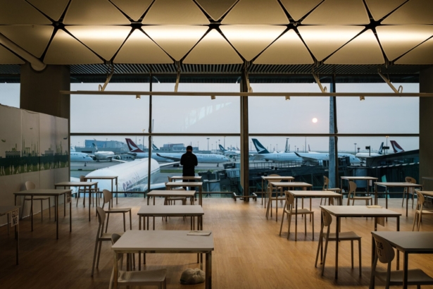 A man waits for the results of a mandatory COVID-19 test while standing at a window at Hong Kong International Airport on Oct. 4, 2020. (Anthony Wallace/AFP via Getty Images)