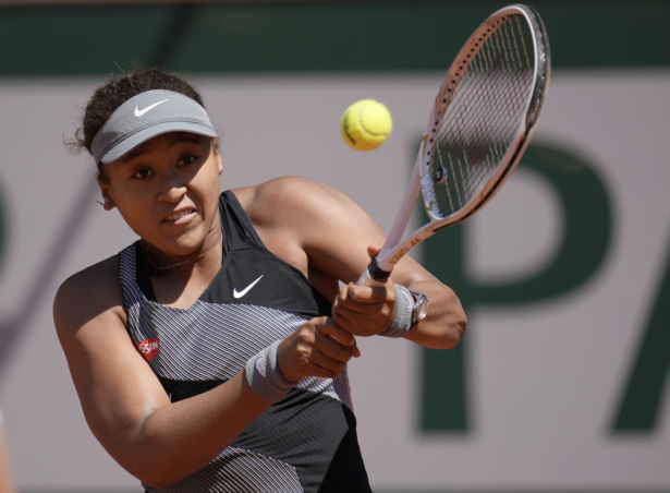 Japan's Naomi Osaka returns the ball to Romania's Patricia Maria Tig during their first round match of the French open tennis tournament at the Roland Garros stadium in Paris, France, on May 30, 2021. (Christophe Ena/AP Photo)