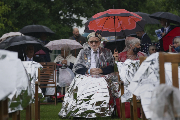 D-Day veterans arrive to watch the official opening of the British Normandy Memorial in France via a live feed, during a ceremony at the National Memorial Arboretum in Alrewas, England, on June 6, 2021. (Jacob King/PA via AP)